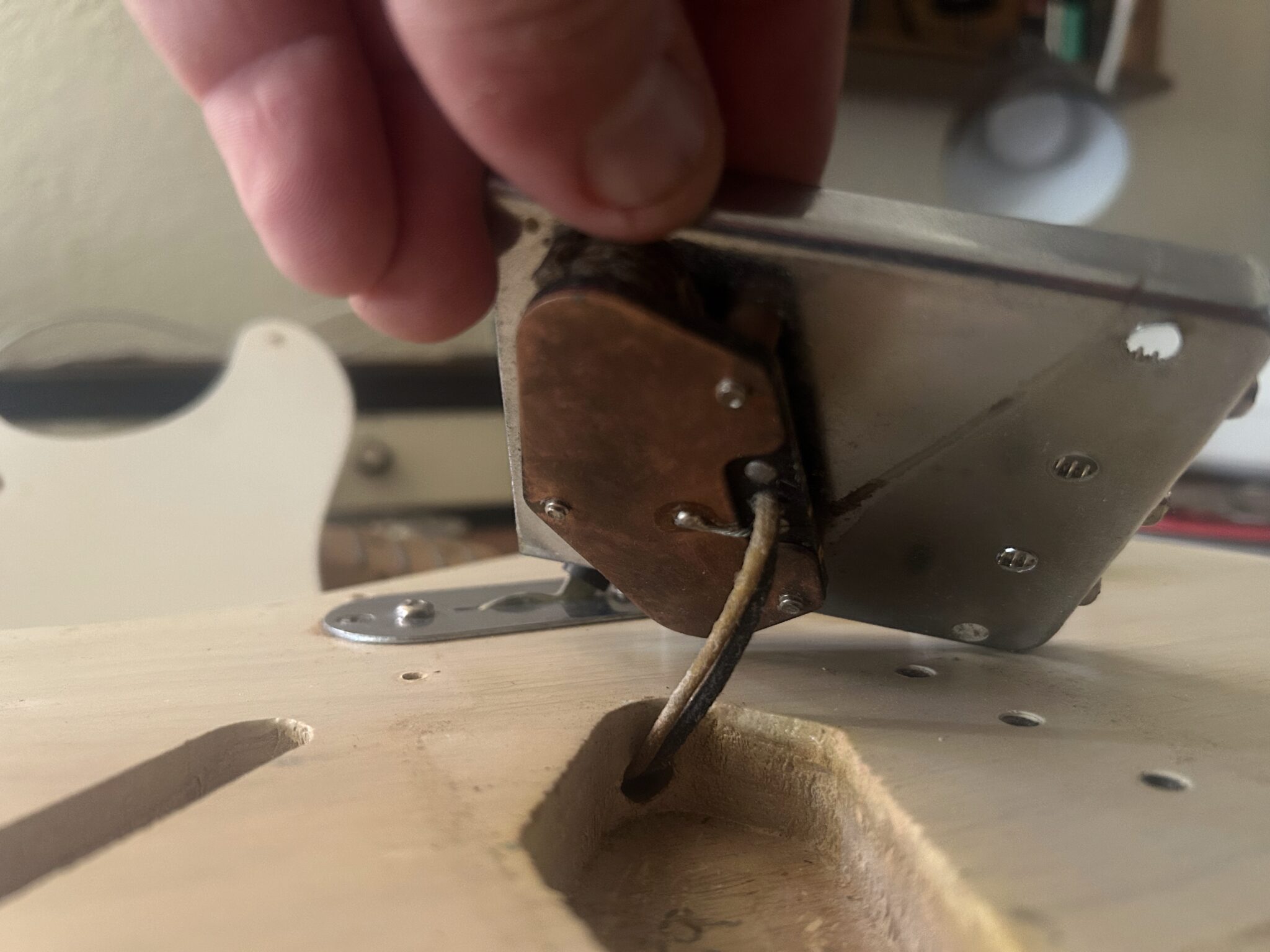 Back of 1959 Fender Telecaster bridge pickup showing chrome baseplate, period-correct construction, and formvar-coated wire leads