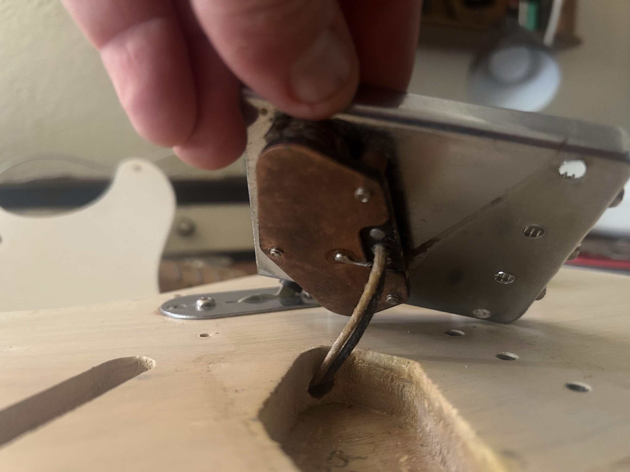 Back of 1959 Fender Telecaster bridge pickup showing chrome baseplate, period-correct construction, and formvar-coated wire leads