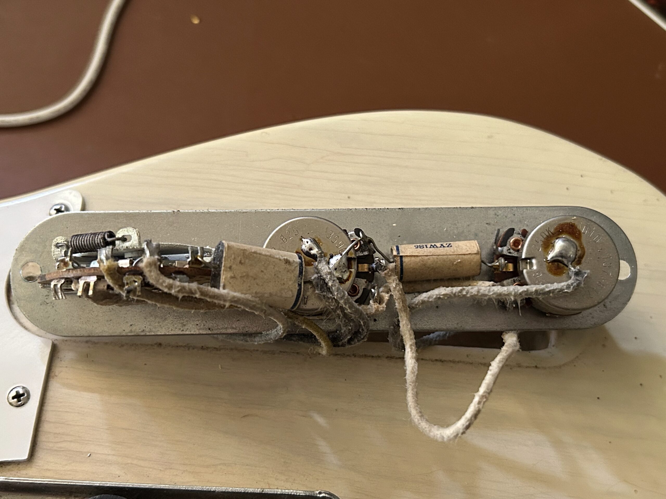 1959 Fender Telecaster wiring harness showing cloth-covered wire, Stackpole or Centralab pots, and brown chicklet paper tone capacitor