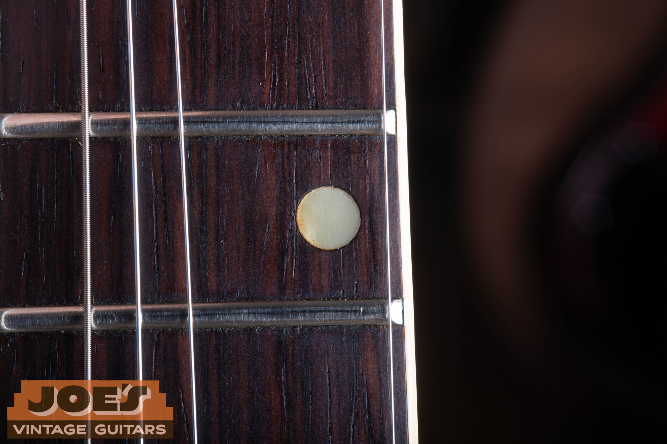 Close-up of pearl dot inlays on the dark Brazilian rosewood fretboard of a 1959 Gibson ES-330