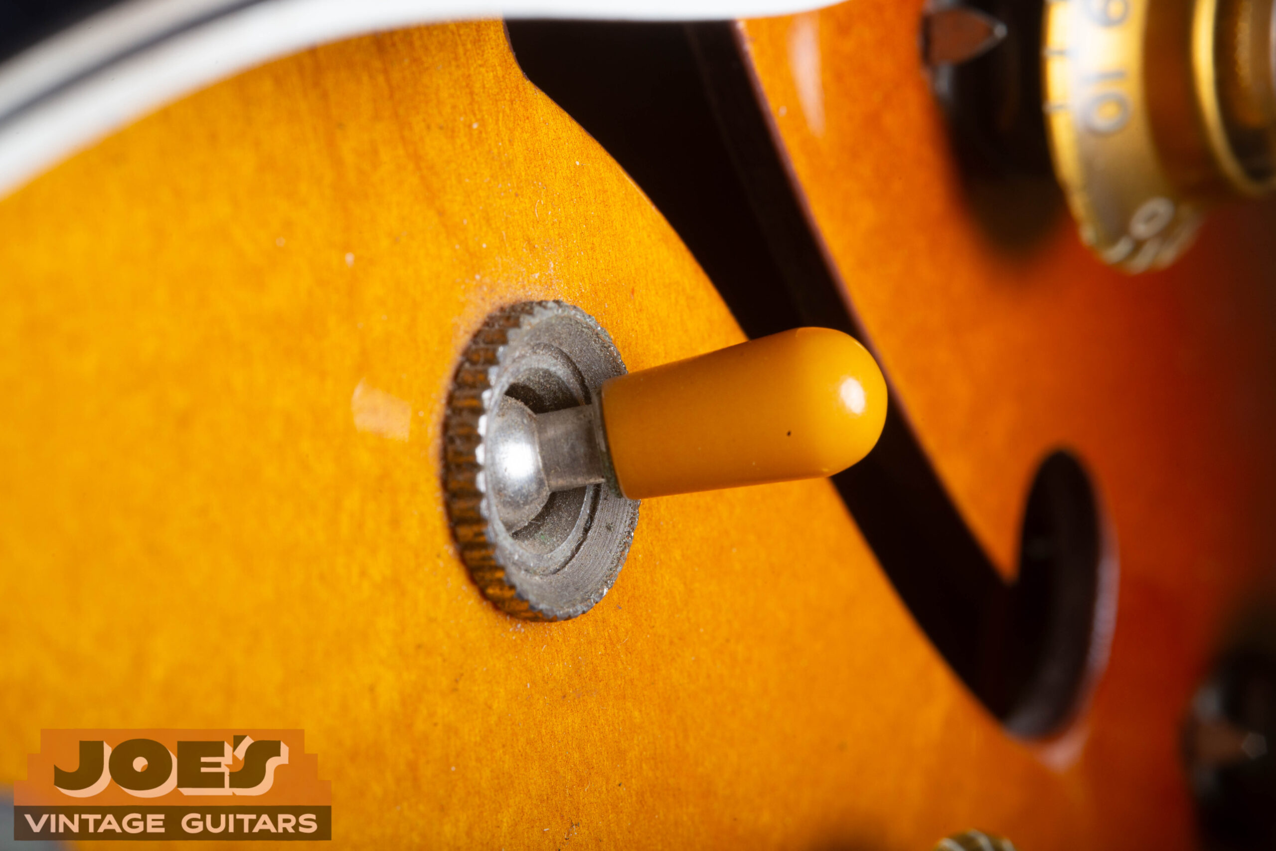 Close-up of the amber barrel switch tip on a 1959 Gibson ES-330 toggle switch