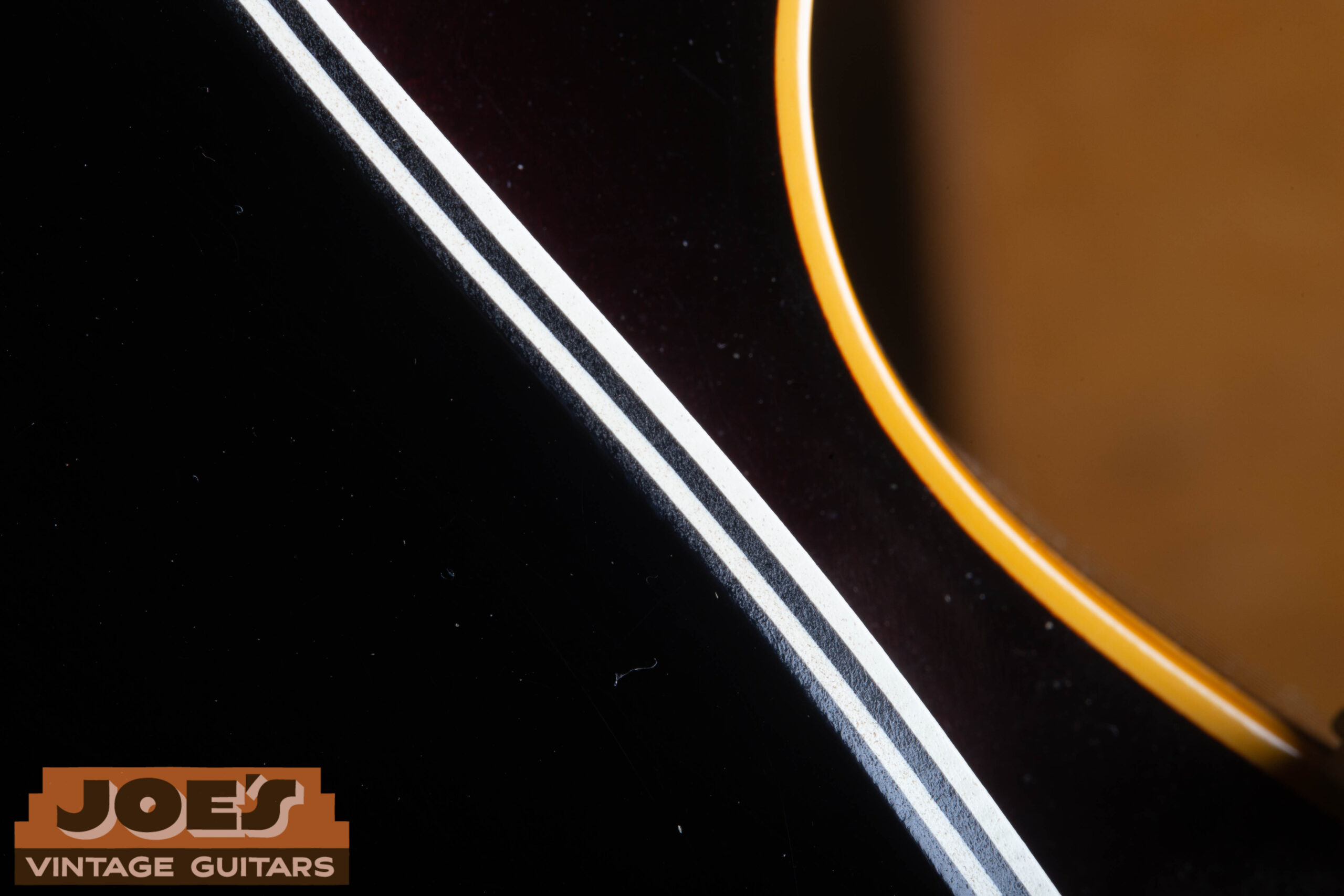 Edge view of the four-ply black pickguard on a 1959 Gibson ES-330 showing the laminate layers