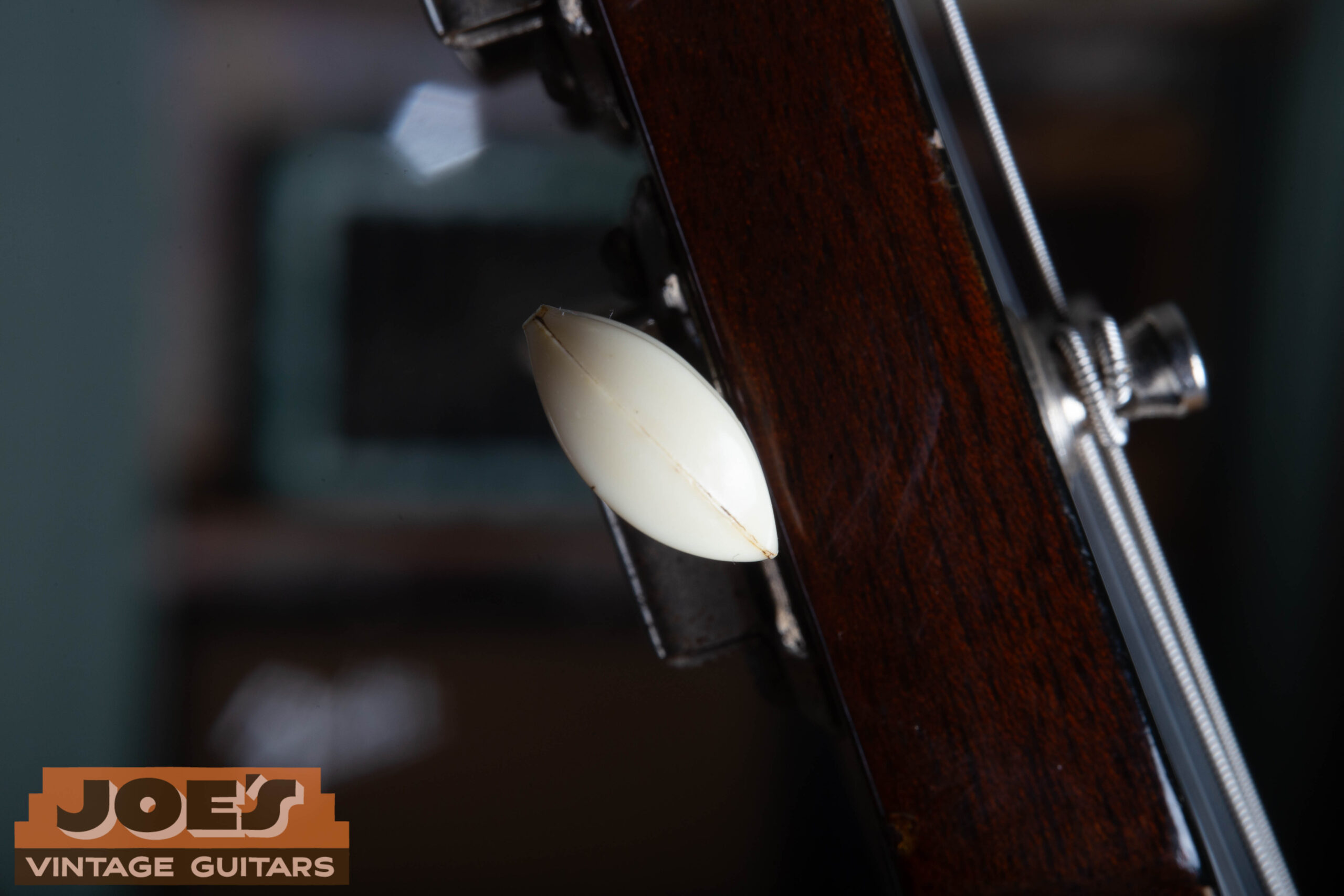 Close-up of a 1959 Gibson ES-330 Kluson tuner button showing the visible seam and appropriate celluloid aging