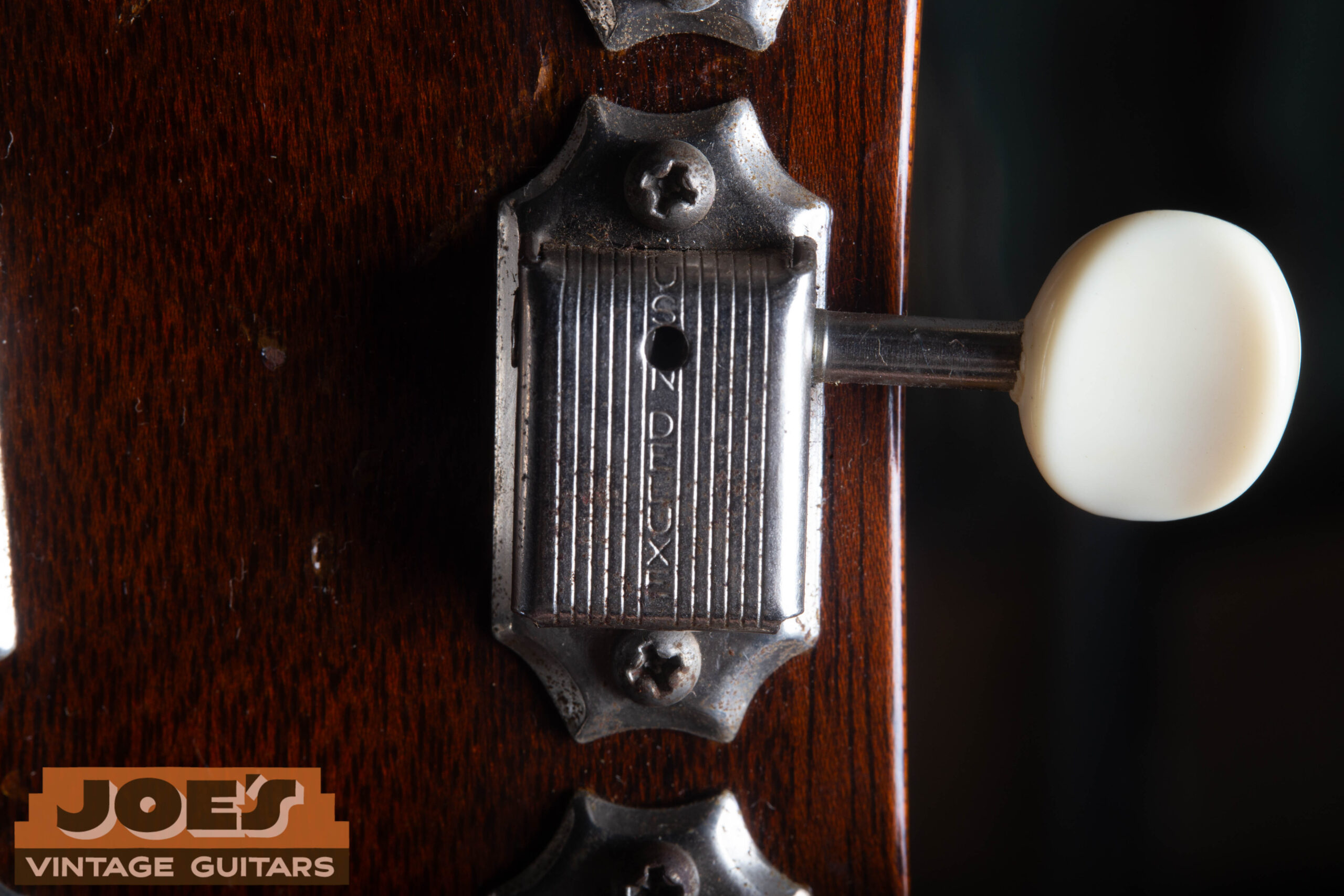 Close-up of single-line Kluson Deluxe stamp on the back of a tuner cover from a 1959 Gibson ES-330