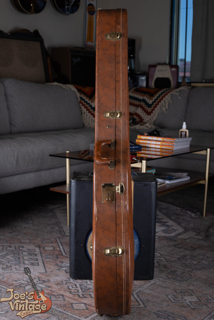 Side view of a 1959 Stone case for a Gibson ES-335 showing the original spring-loaded briefcase-style latches and textured covering.