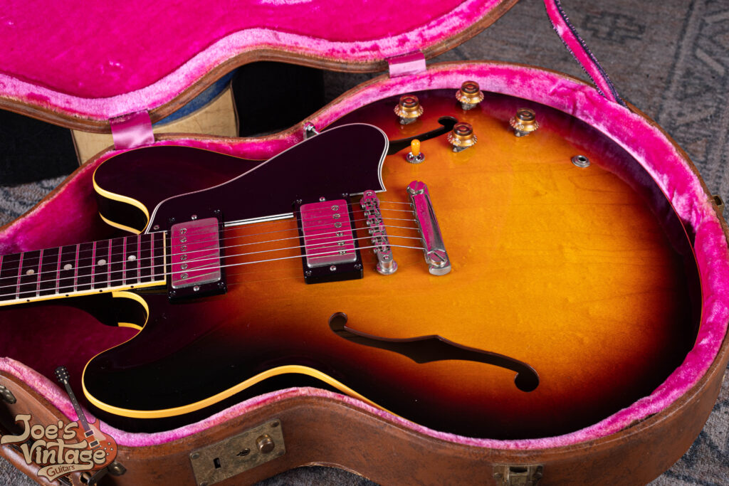 A 1959 Gibson ES-335TD in original sunburst finish resting in a vintage brown Lifton case with pink interior at Joe's Vintage Guitars.