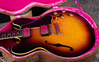 A 1959 Gibson ES-335TD in original sunburst finish resting in a vintage brown Lifton case with pink interior at Joe's Vintage Guitars.