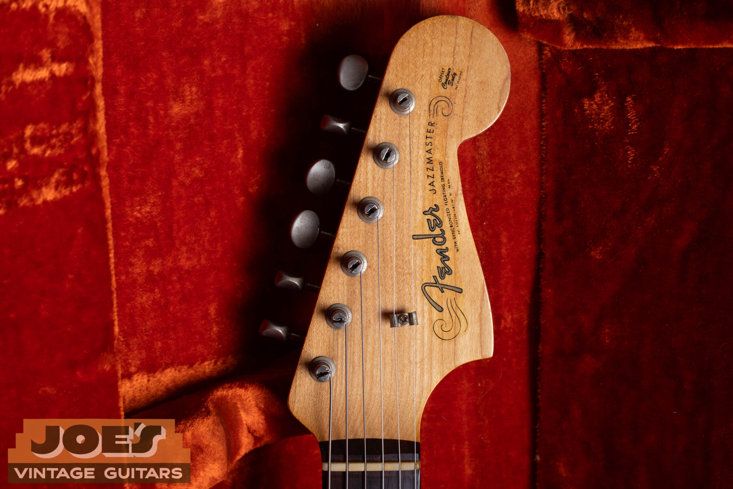 1960s Fender Jazzmaster headstock with spaghetti logo — pre-CBS thin flowing cursive Fender script in silver chrome, clay dot fingerboard, single-line Kluson tuners