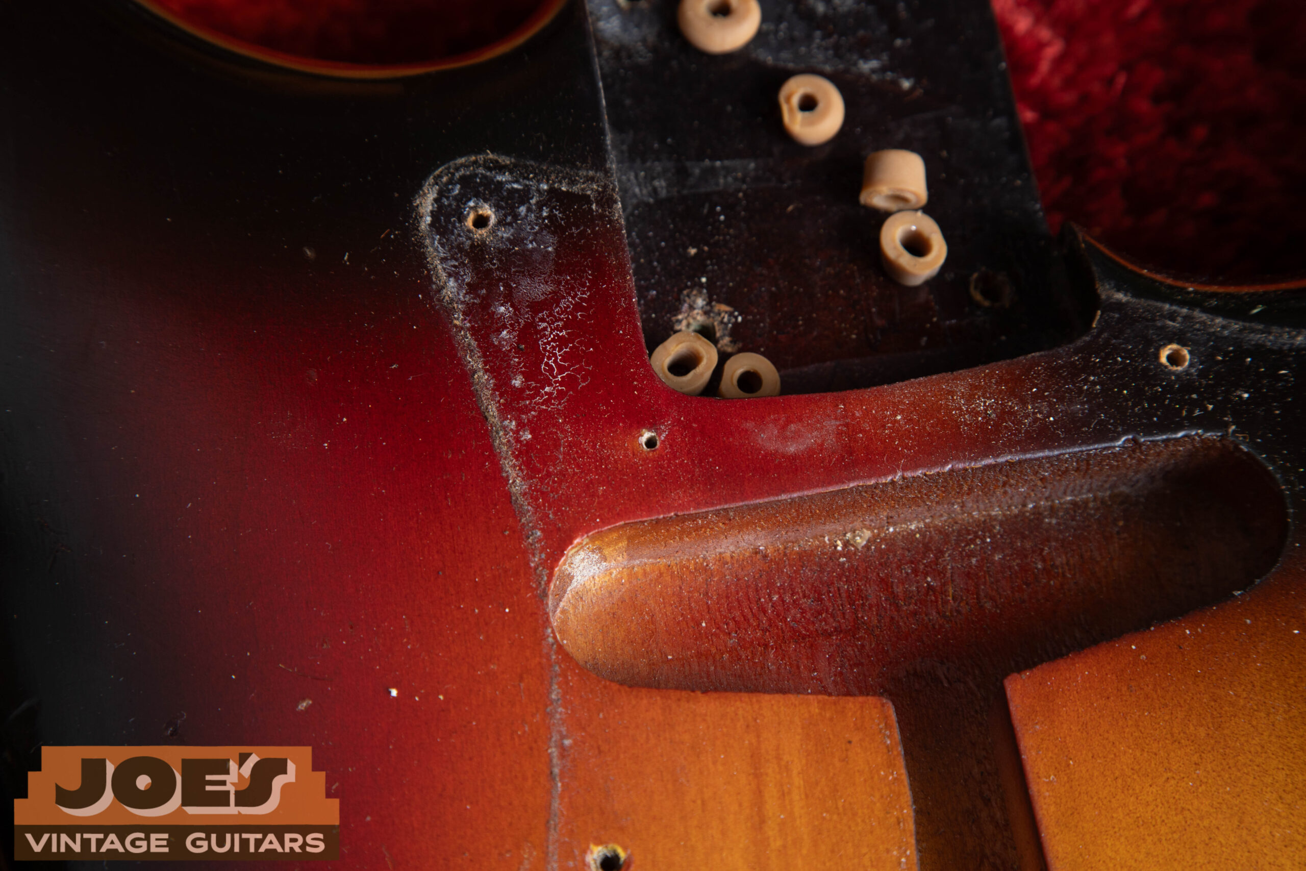 Second finishing nail hole on 1962 Fender Stratocaster body face — under pickguard, confirming original Fullerton body finishing method