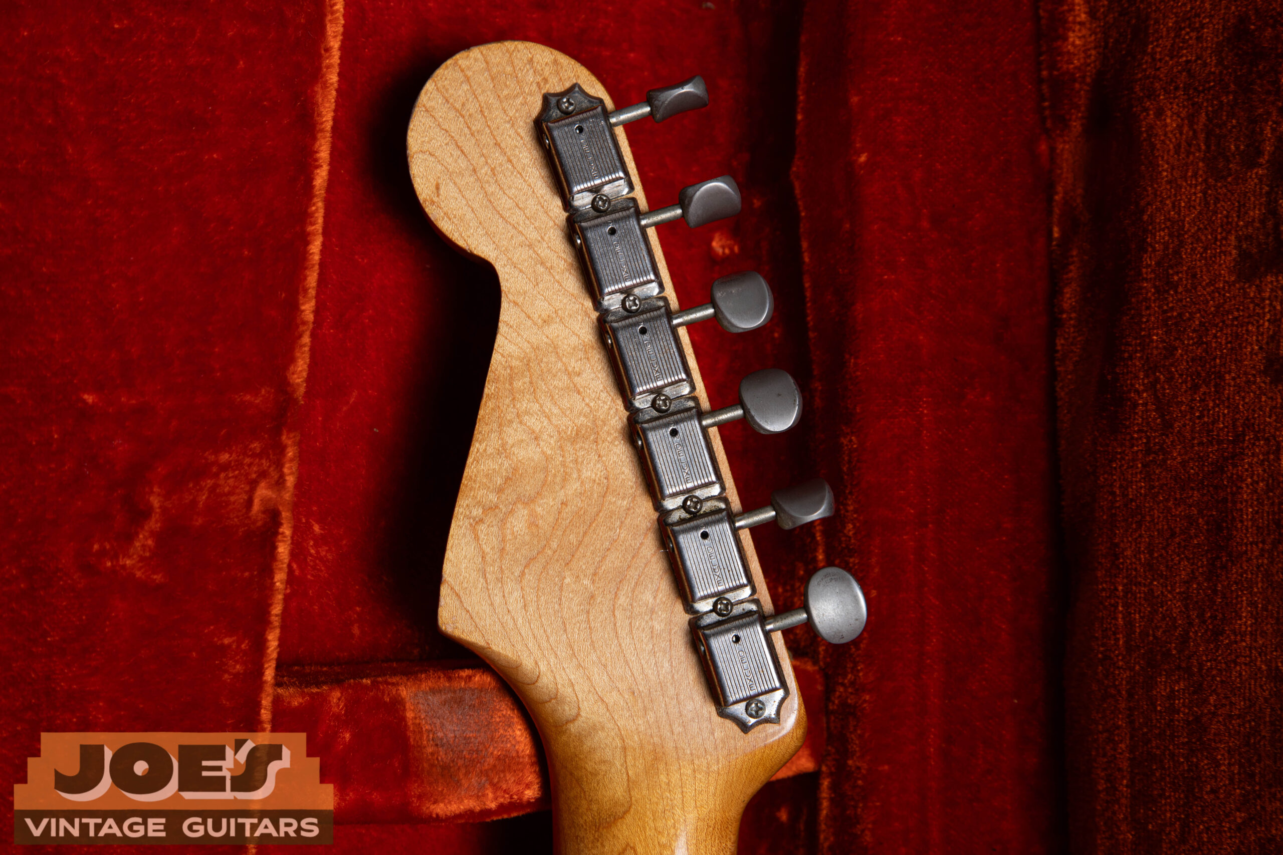 Back of 1962 Fender Stratocaster headstock showing Kluson Deluxe single-line tuners with Kluson Deluxe stamp on all-metal chrome gear housing backs