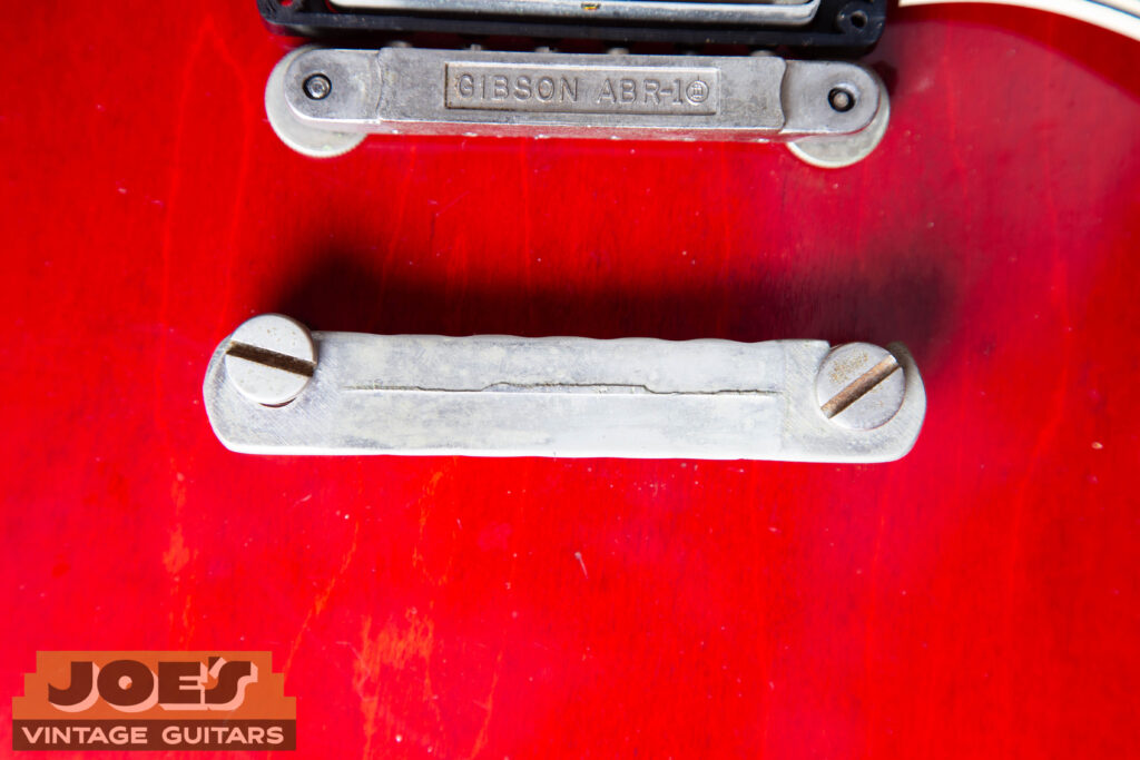 Forensic view of a 1962 Gibson ES-335 hardware set featuring a nickel-plated 'no-wire' ABR-1 bridge and the back of a lightweight stop tailpiece with the original short seam.