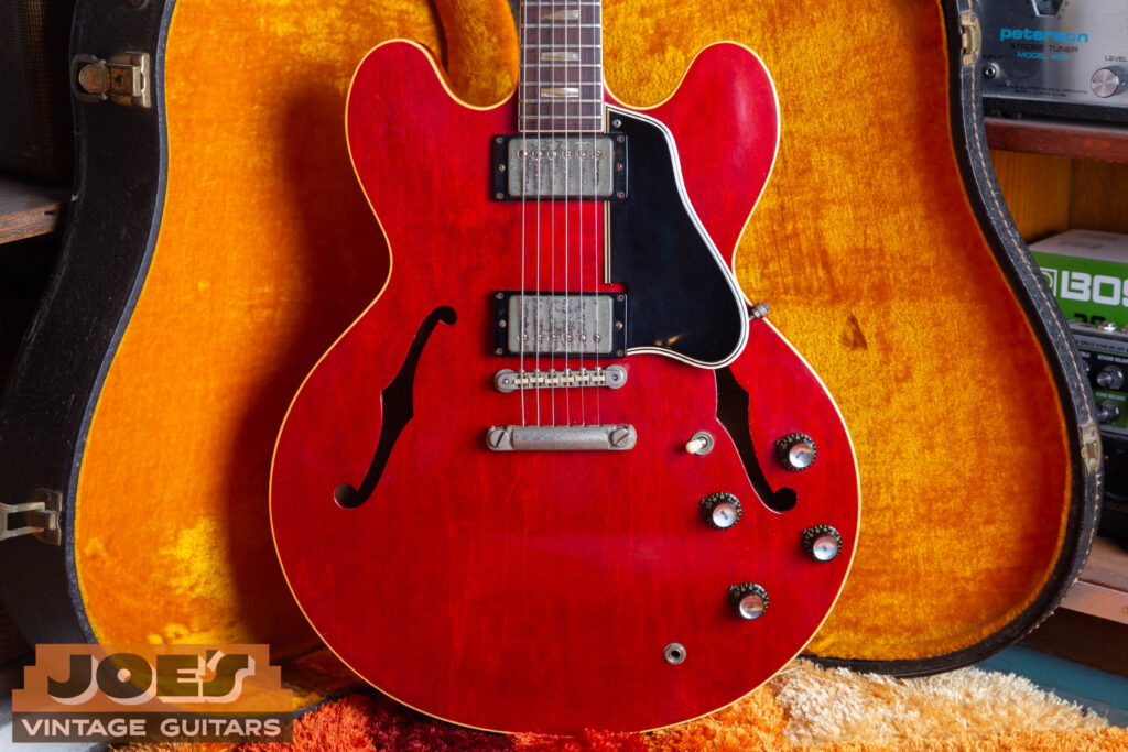 Vintage 1962 Gibson ES-335TD in Cherry Red finish featuring original cellulose nitrate block inlays, Mickey Mouse ear body shape, and nickel-plated ABR-1 bridge.
