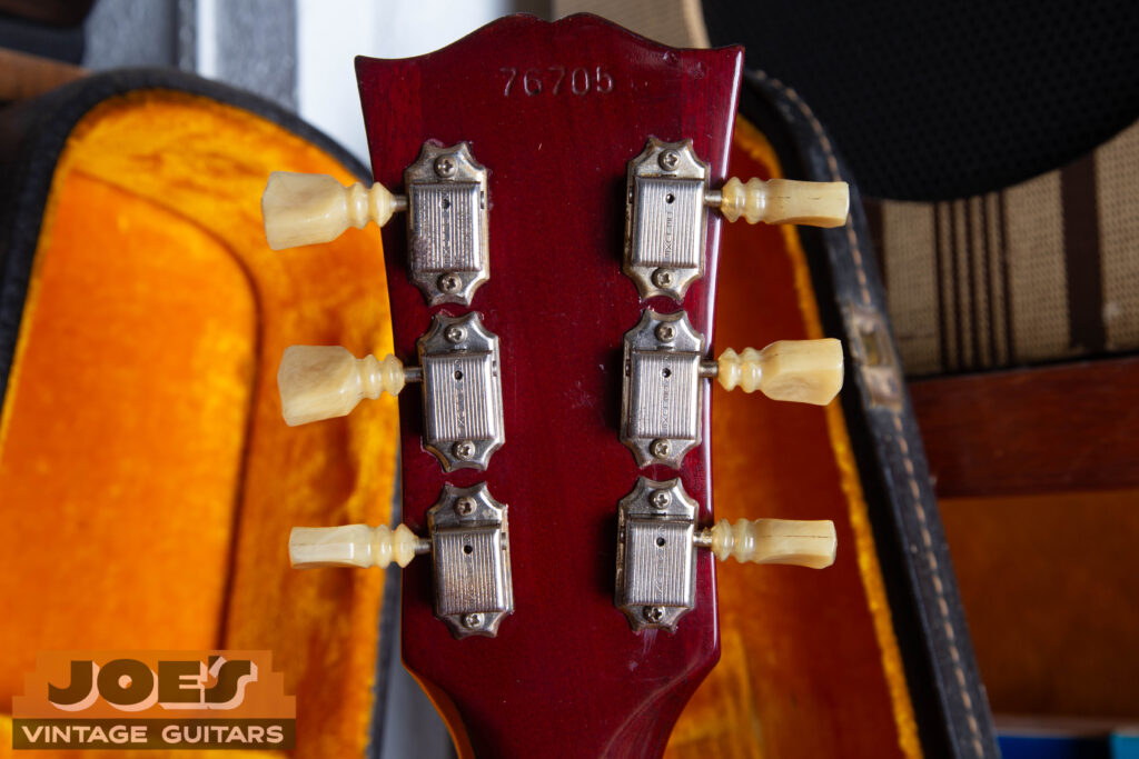 Close-up of original 1962 Gibson Kluson Deluxe single-line tuners featuring the transitional double-ring plastic buttons and original nickel plating.