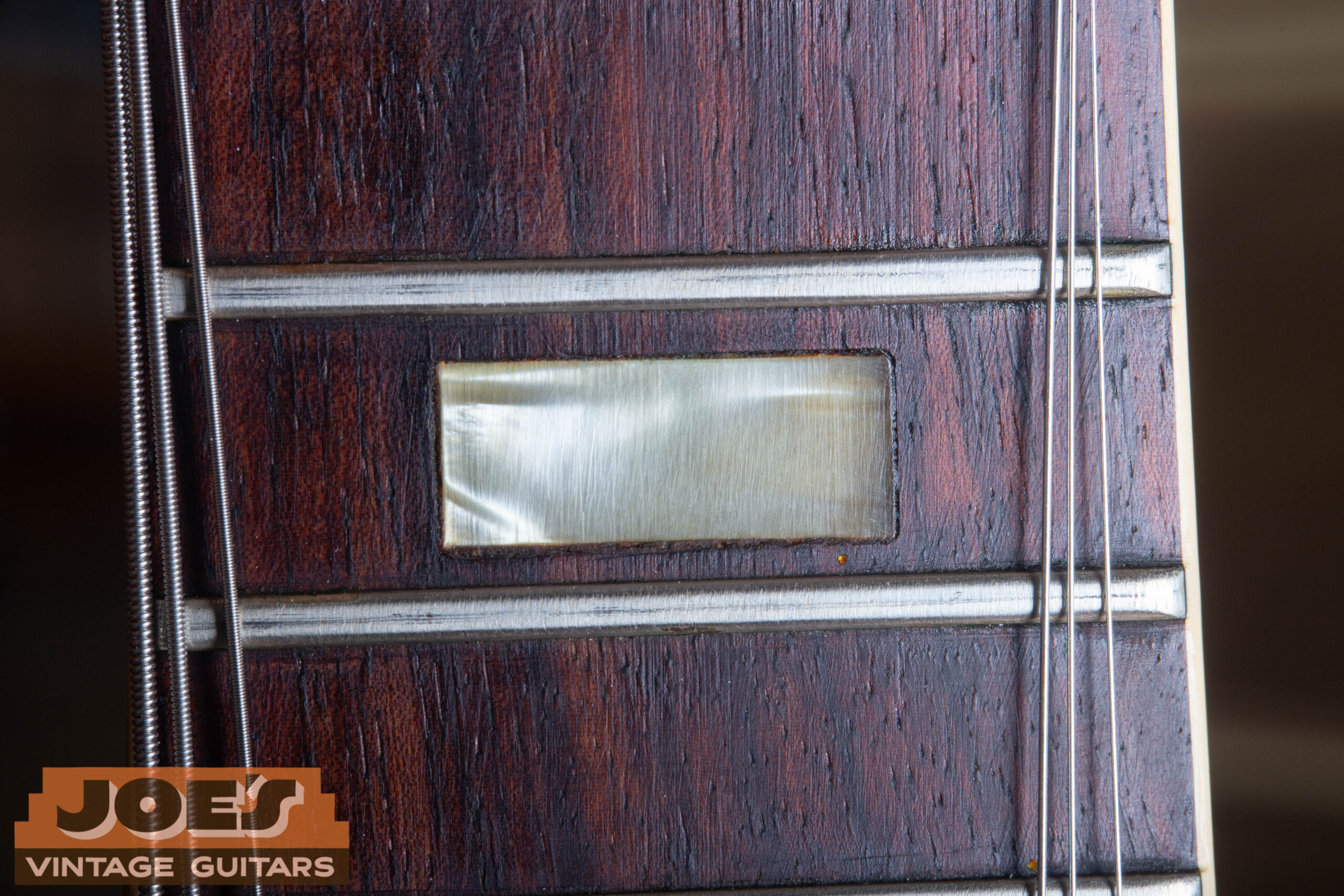 1966 Gibson ES-335 fingerboard block inlay close-up — mother-of-pearl rectangular block inlay showing natural iridescence and period-correct aging