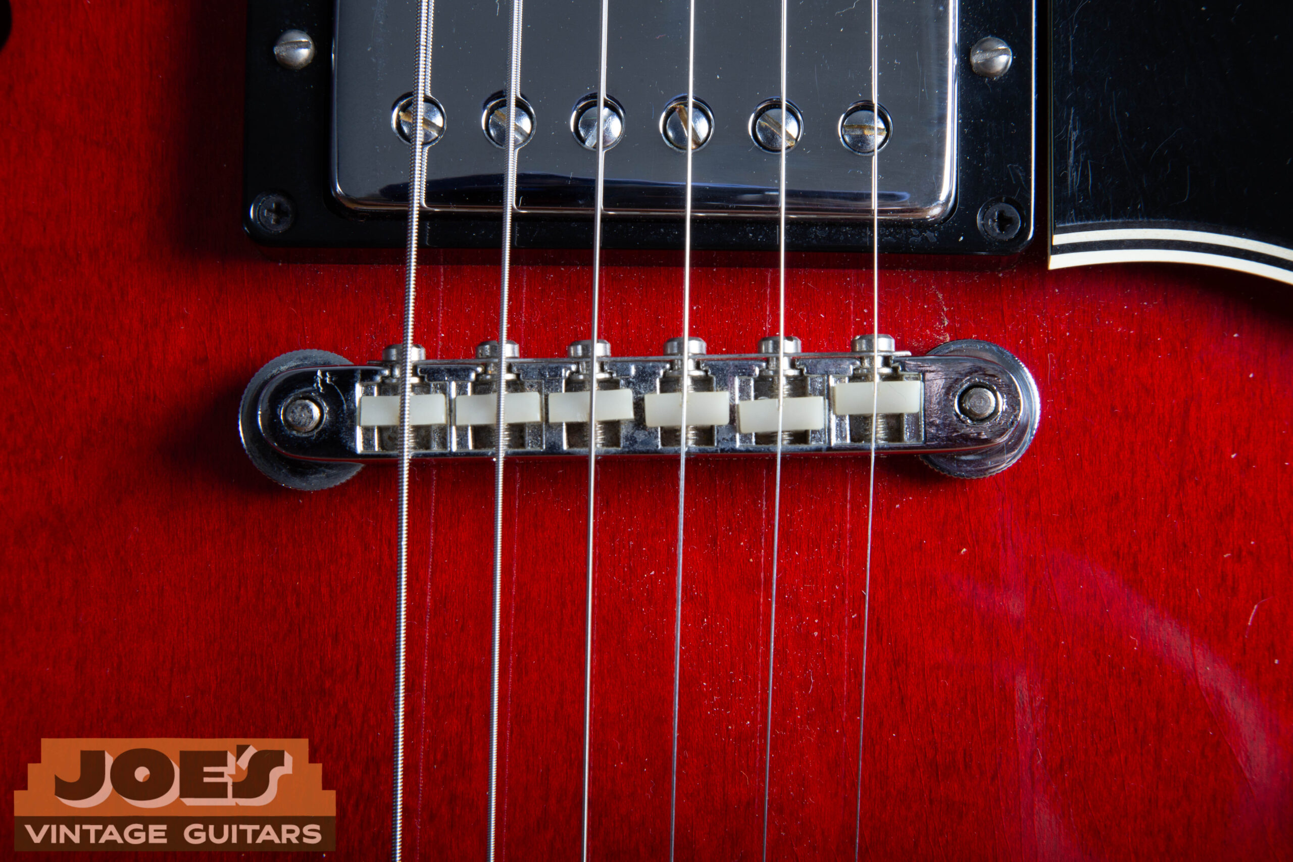 1966 Gibson ES-335 ABR-1 Tune-o-matic bridge with original nylon saddles and retainer wire — correct period bridge hardware showing authentic chrome aging