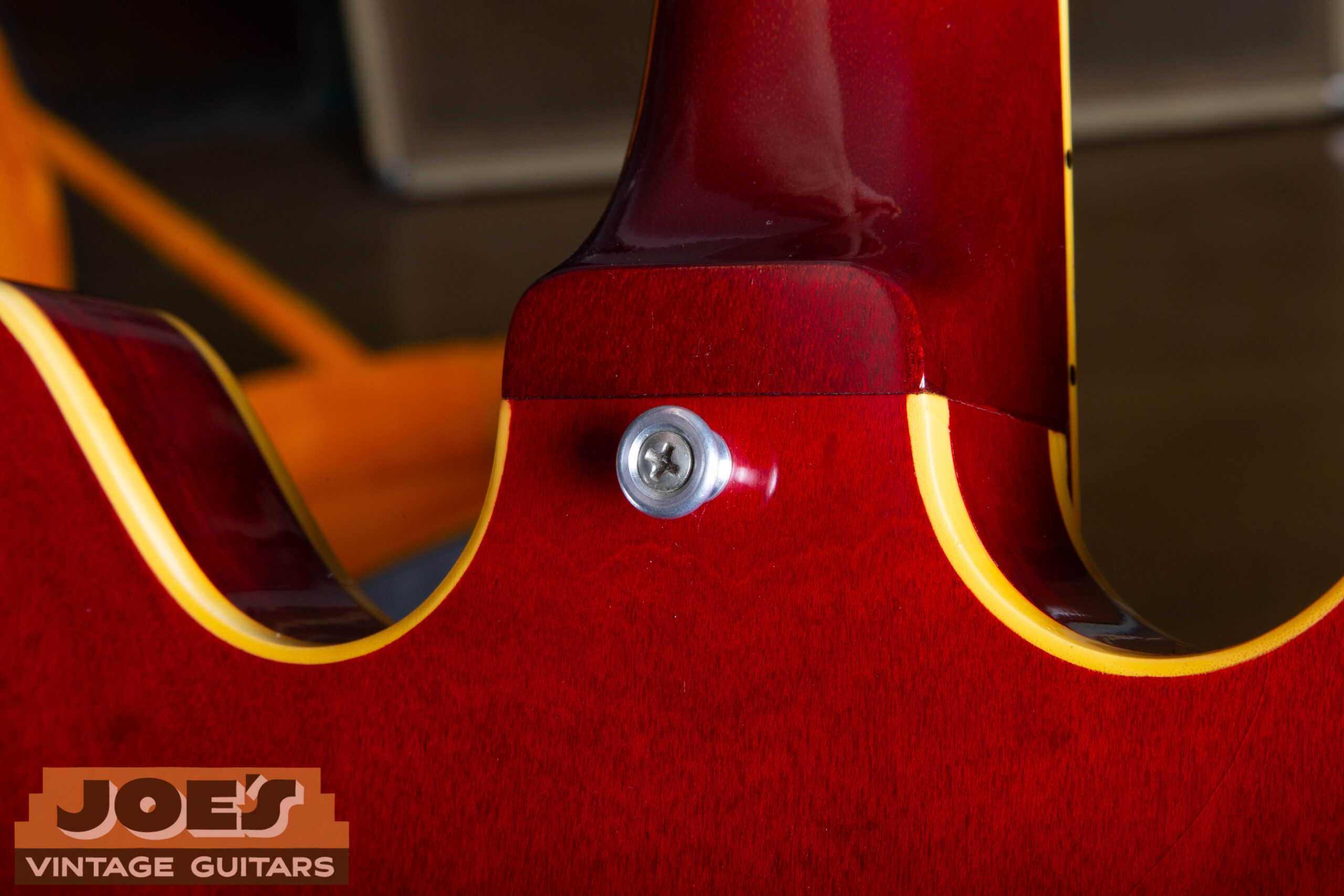 1966 Gibson ES-335 aluminum strap button at upper shoulder — correct aluminum button with chrome screw, less shiny than chrome hardware on the guitar