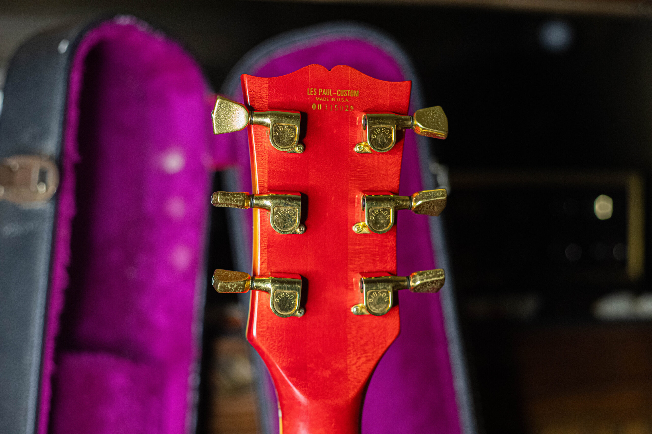 Gold waterslide decal serial number on the back of the headstock of a 1975 Gibson Les Paul Custom — the decal prefix serial number system used on Gibson guitars from 1975 through 1977