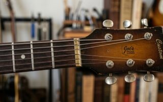 Close-up of a vintage guitar headstock featuring a 1970s era brass nut modification at Joe’s Vintage Guitars