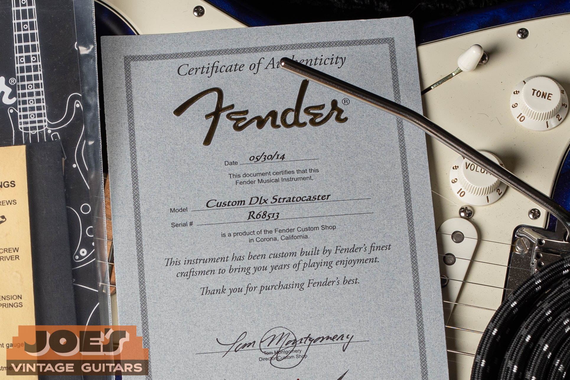 Fender Custom Shop Certificate of Authenticity showing an R-prefix serial number on a Custom Deluxe Stratocaster — proving definitively that R prefix does not mean Relic or Reissue