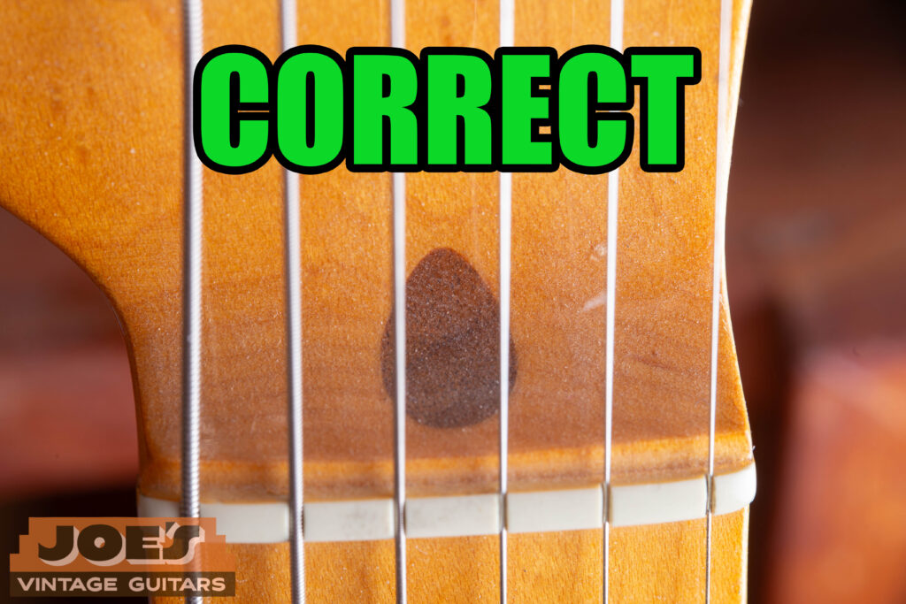 The walnut plug on a Fender neck that indicates a real Fender guitar.