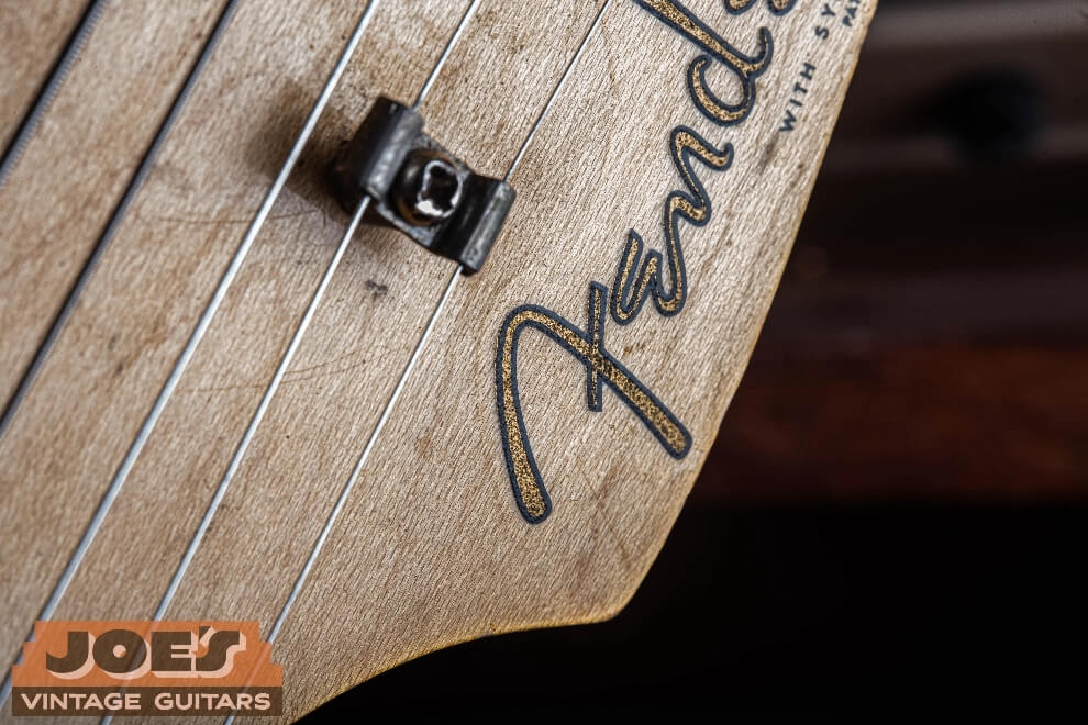 Fender vintage waterslide headstock decal sitting raised above the lacquer finish