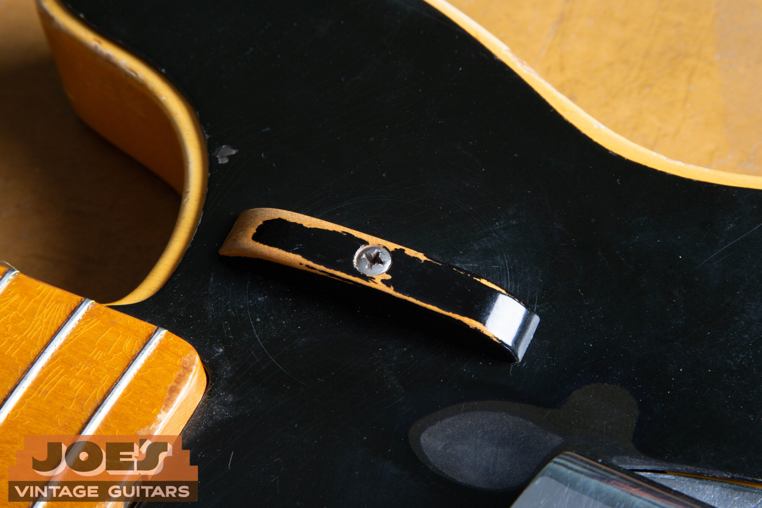 Finger rest (tug bar) on a 1952 Fender Precision Bass — wood painted black