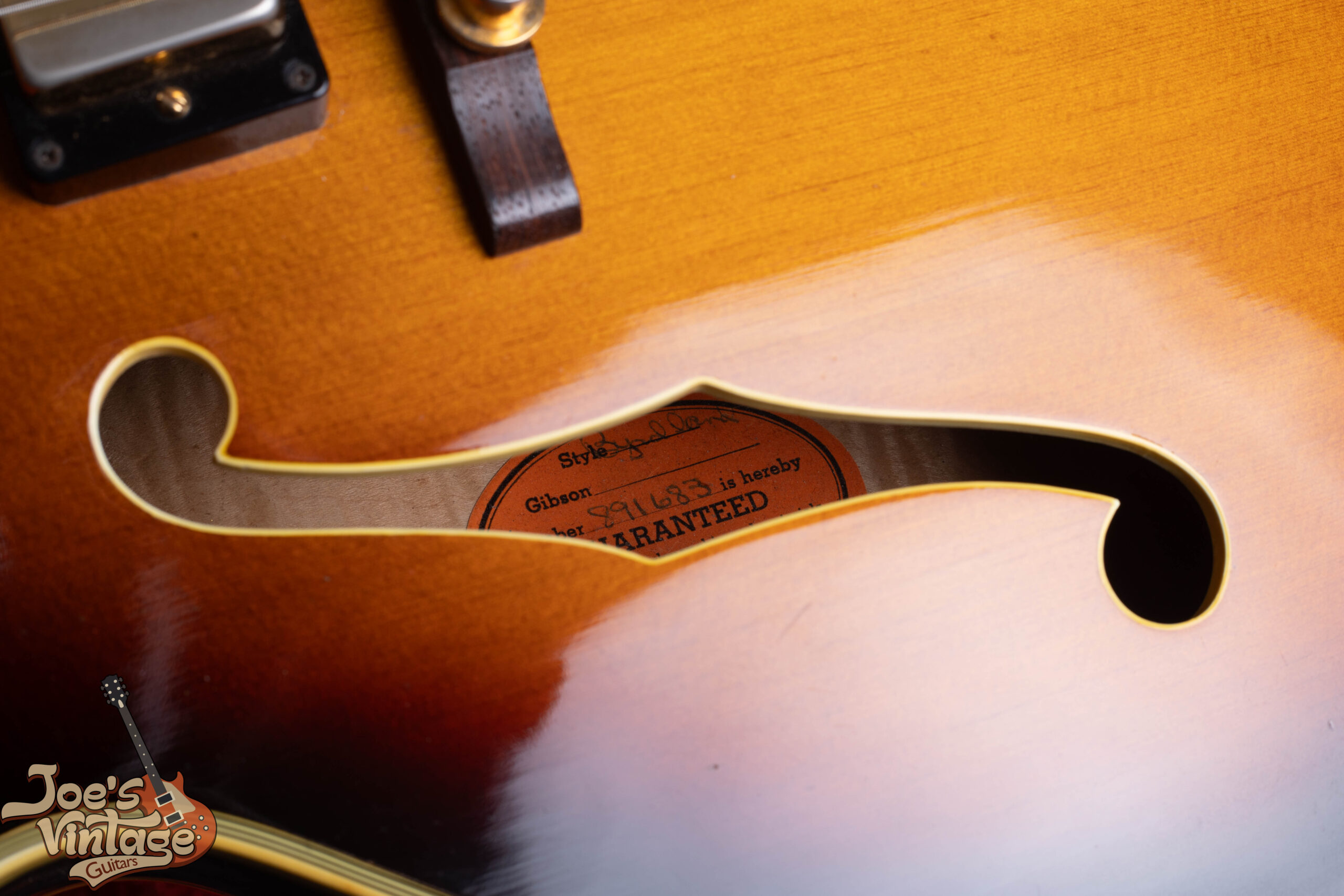 Gibson Byrdland orange oval label inside body showing A-series serial number — used 1955 to 1969 pre-Norlin era