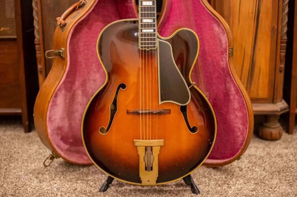 A vintage Gibson L-5C acoustic archtop guitar in a sunburst finish, featuring a 17-inch body with a Venetian cutaway and carved spruce top. The image highlights the clean, acoustic design without any mounted pickups or electronics, showcasing the original wood and craftsmanship.