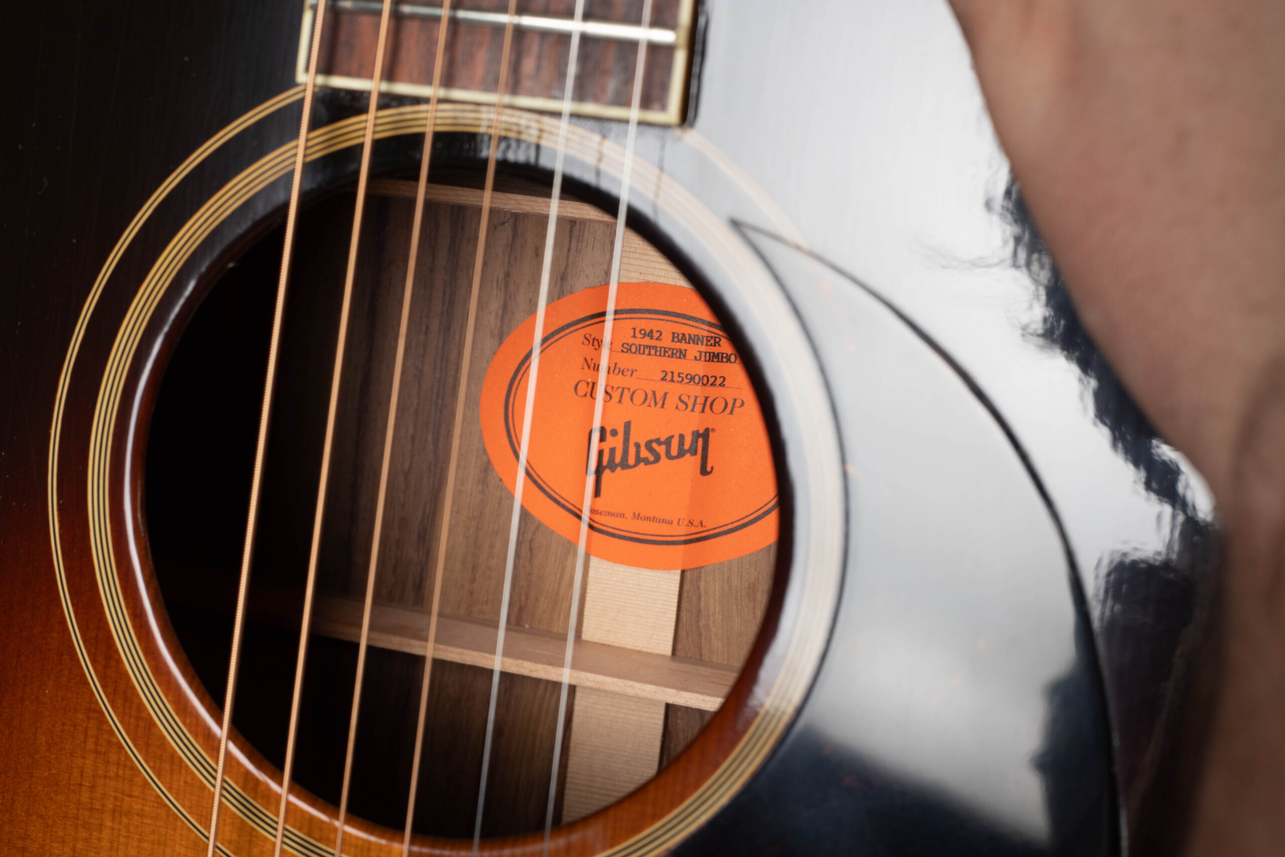 Vintage Gibson orange oval interior label showing handwritten serial number inside the body of the guitar