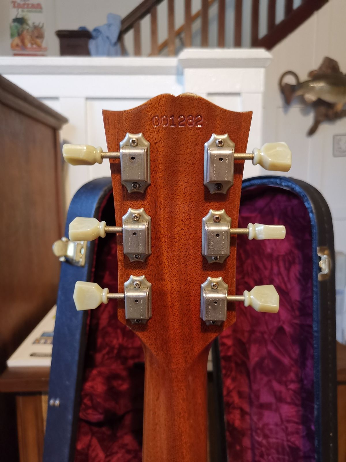 Impressed serial number on the back of the headstock of a Gibson SG Historic Reissue Custom Shop guitar — physically pressed into the wood rather than ink stamped