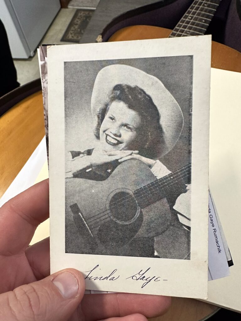 linda-1950s-with-martin-0-18 Black and white 1950s historical photo of Linda playing her vintage Martin 0-18 on the radio. Joe’s Vintage Guitars specializes in buying Martin guitars with documented history and provenance. Get a free professional Martin guitar evaluation and market value assessment.