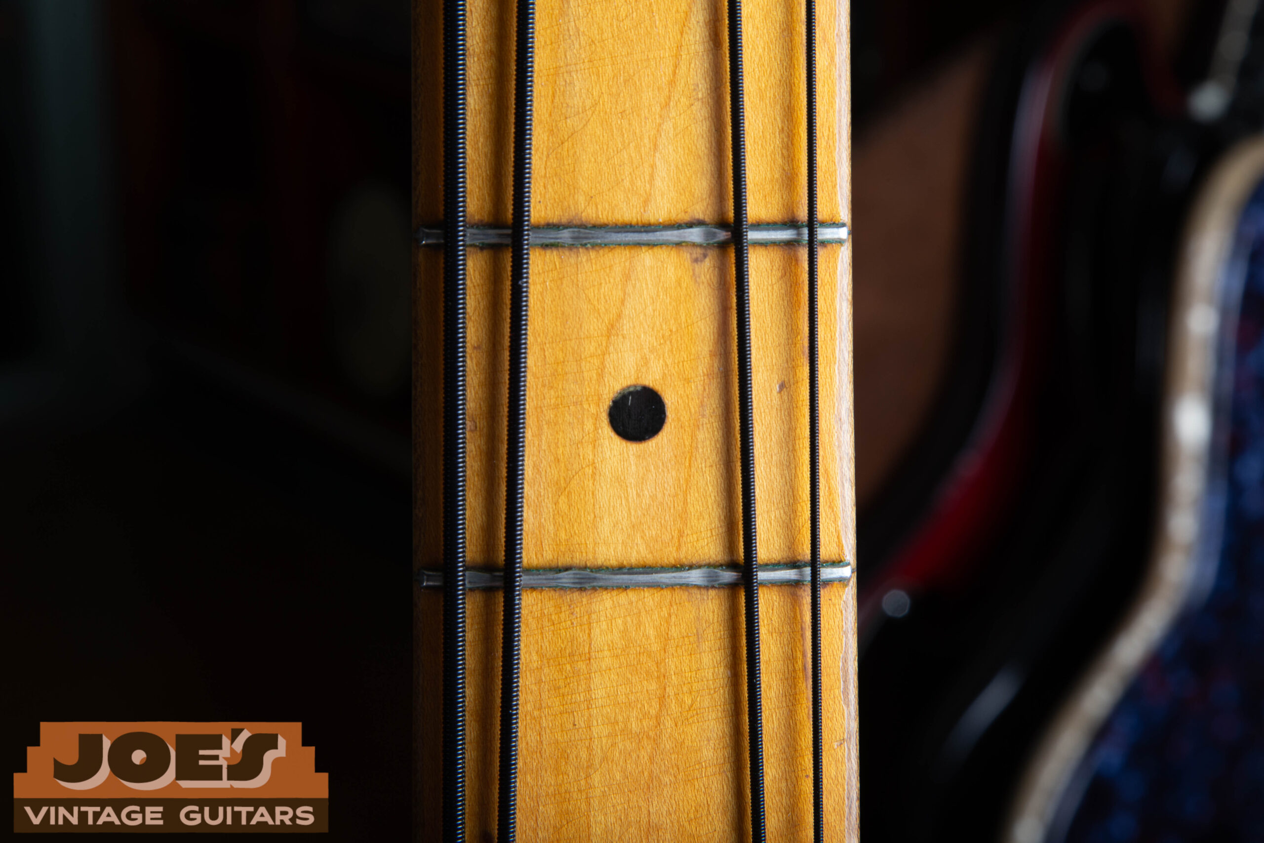 Black dot position inlays on a maple fingerboard of a 1959 Fender Precision Bass