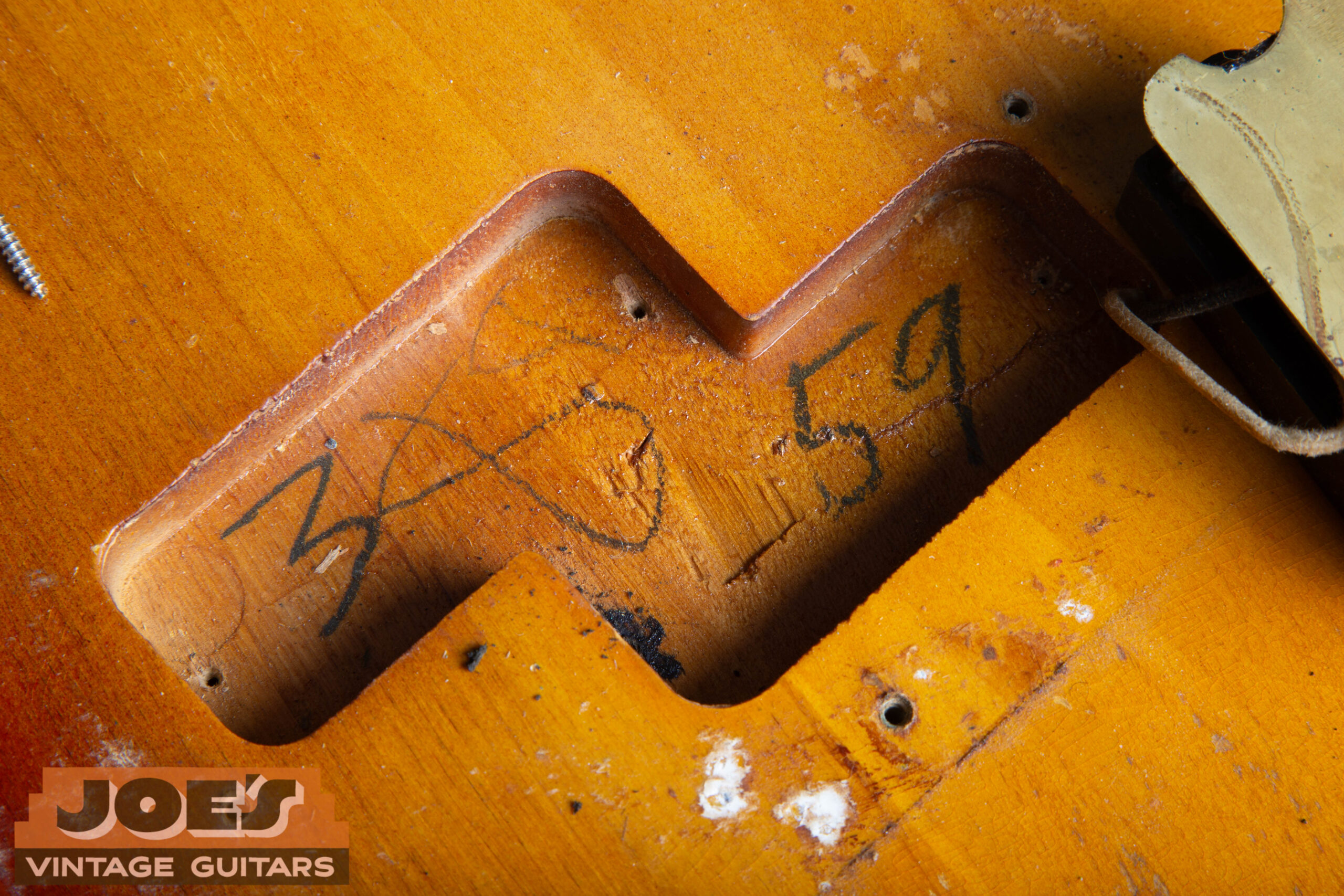 1959 factory body cavity date stamp inside the neck pocket of a Fender Precision Bass