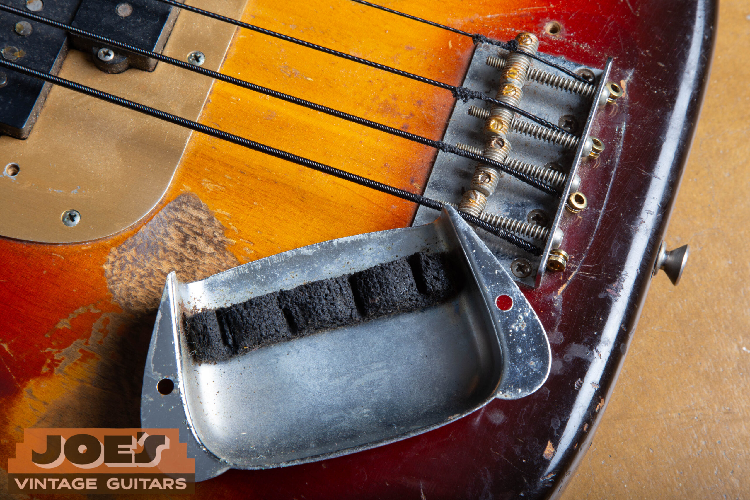 1959 Fender Precision Bass bridge with cover removed and flipped to show the internal foam mute