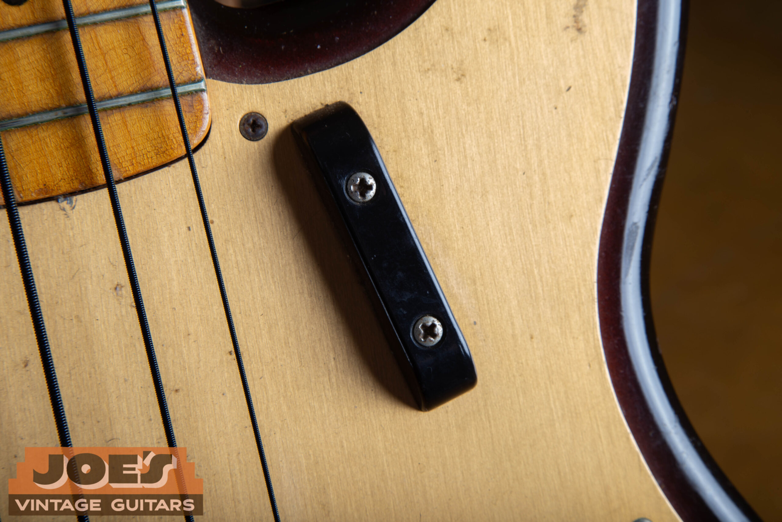 Black plastic tug bar finger rest on a 1959 Fender Precision Bass