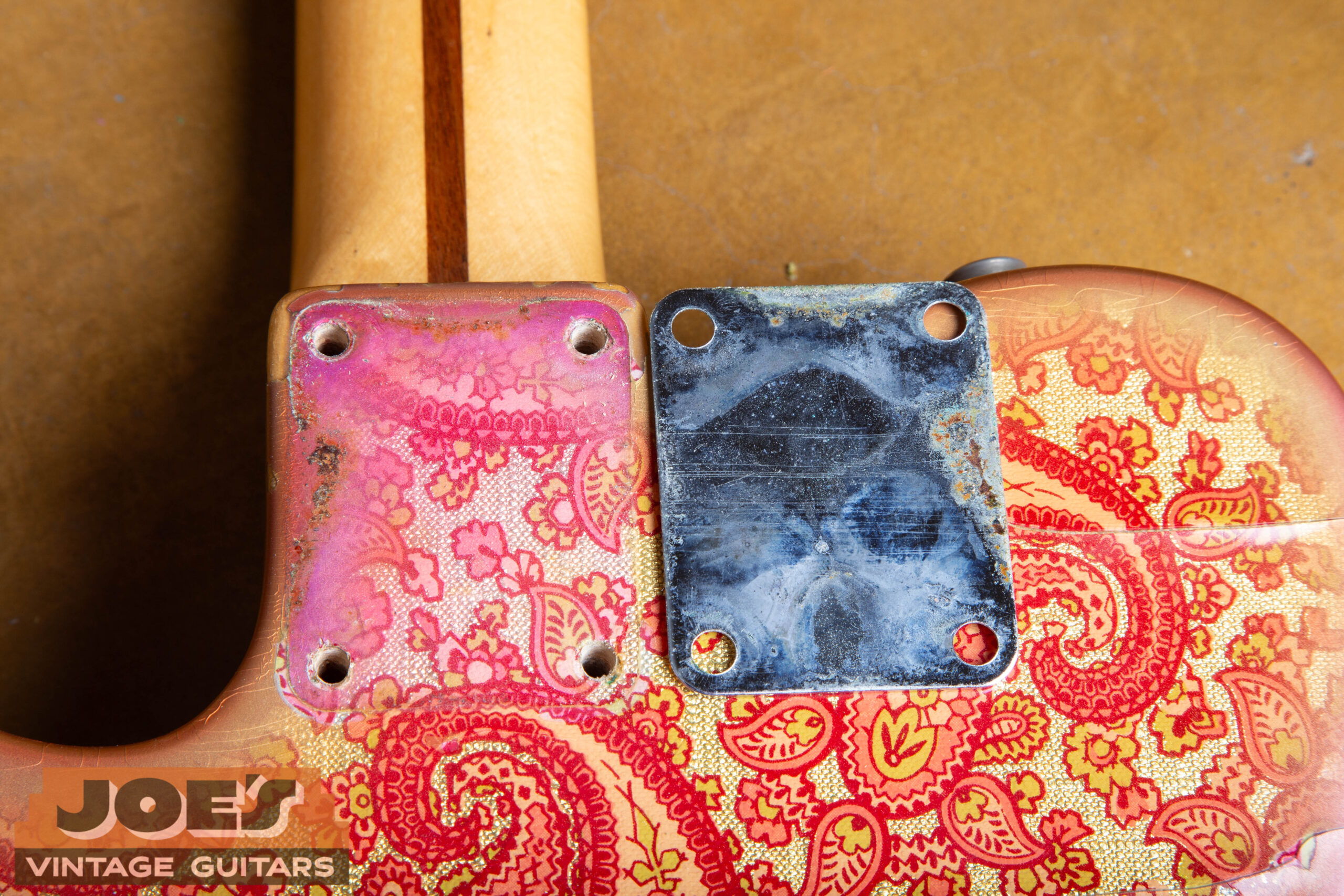 The puzzle piece neck plate shadow on a 1969 Fender Paisley Telecaster showing vibrant protected finish vs aged surrounding body