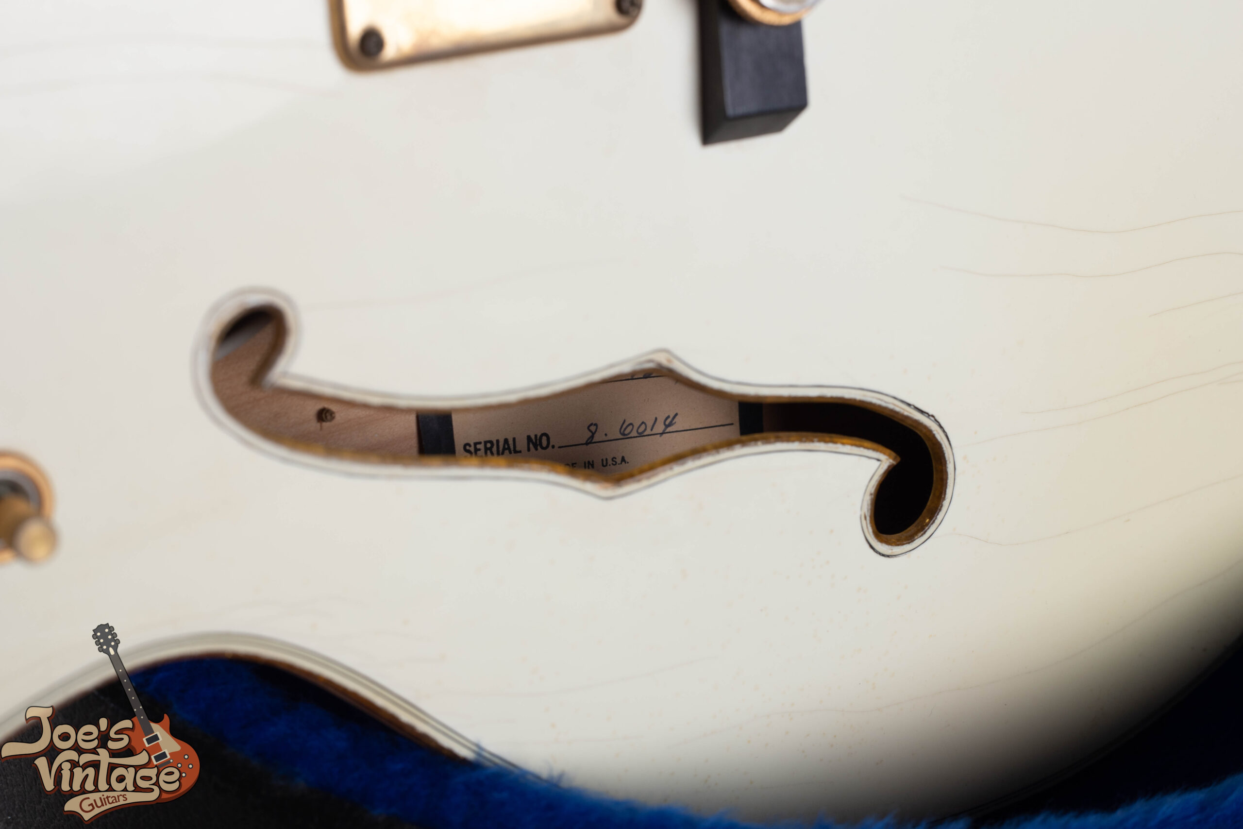 Hyphenated Baldwin-era serial number stamped on the headstock of a 1976 Gretsch White Falcon — the hyphen after the month digits identifies this as a 1972–1981 Booneville-era instrument