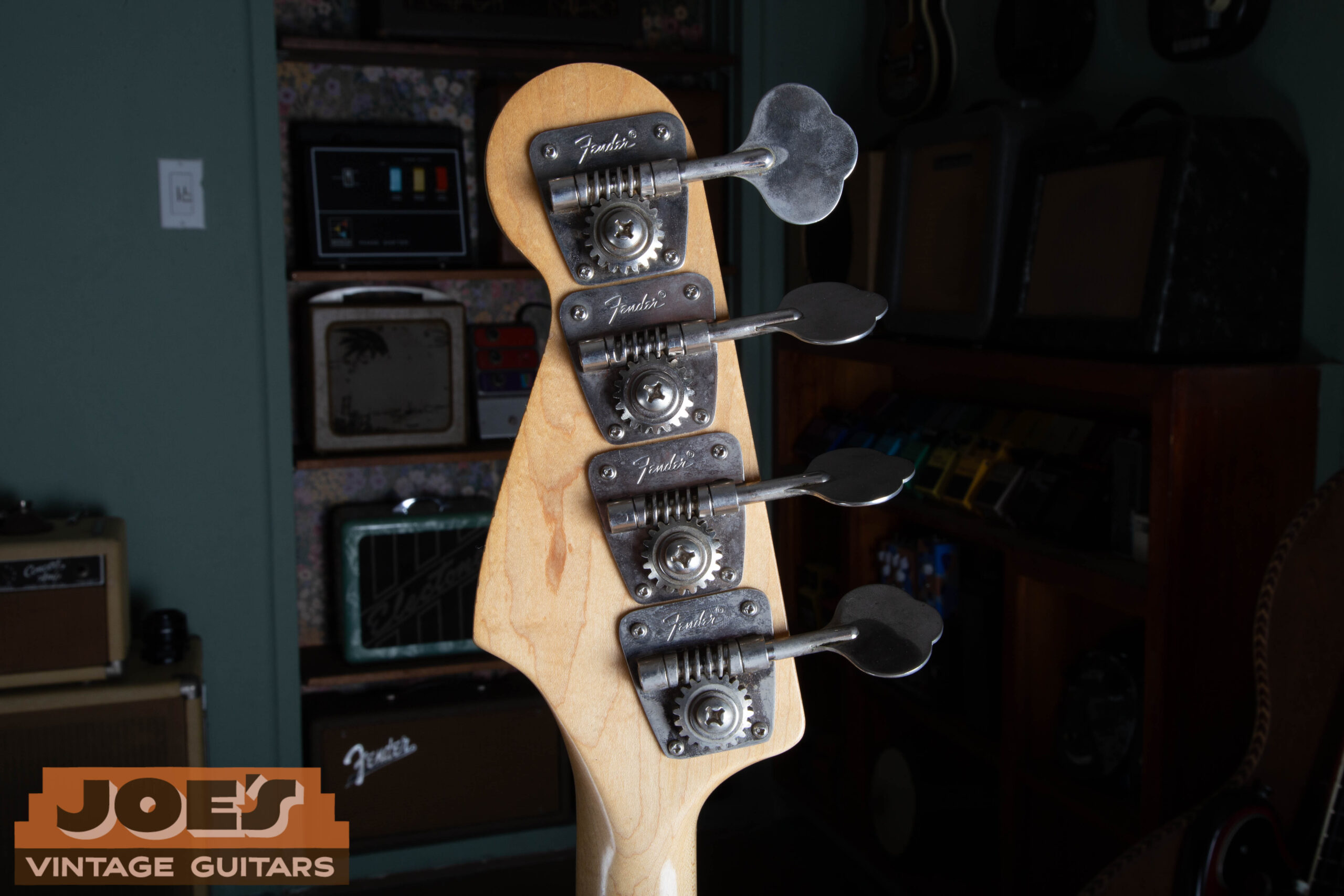 Back of the 1973 Fender Jazz Bass headstock showing the Fender-stamped open-gear tuning machines